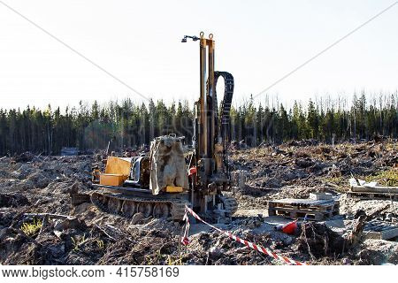 Mini-drilling Rig On Crawler Track On Site Of Sawn Forest Where Large-scale Enterprise Will Be Built