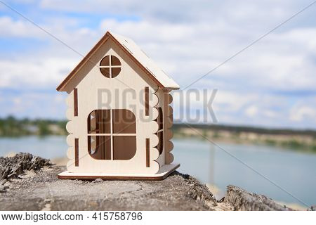 Miniature Wooden House Outdoor Nature. Real Estate Concept. Modern Housing. Eco-friendly Energy Effi
