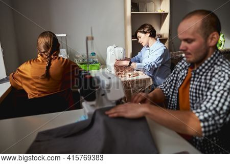 Male Fashion Designer And Women Stitching Fabric With Machines