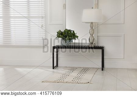 Console Table With Lamp, Bouquet Of Green Branches And Mirror In Room. Interior Design