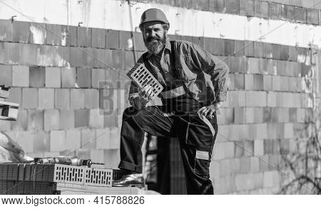 Happy Bearded Man Hold Brick. Brickwork. Man Takes Brick From The Pile. Male Construction Worker Hol
