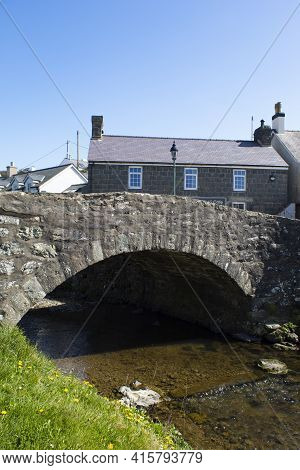 Picturesque Stone Bridge, Aberdaron, Wales. Traditional Old Structure Crossing A Small River In The 