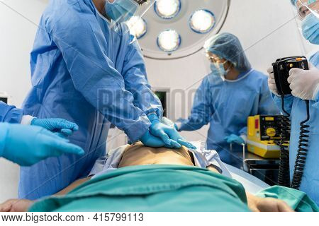 Medical Team In Surgical Gown Help Patient To Making Cpr Cardio Pulmonary Resuscitation In The Opera