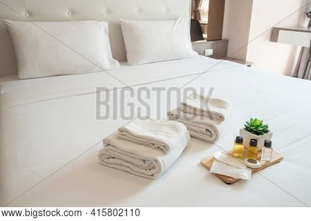 Set Of Hotel Amenities (such As Towels, Shampoo, Soap Etc) On The Bed. Hotel Amenities Is Something 