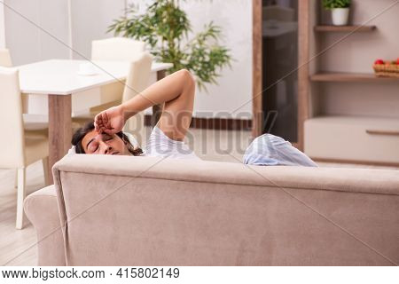 Young lazy man in oversleeping concept at home