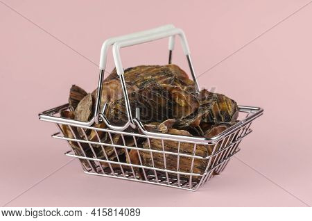 Shopping Basket With Dog Treats On A Pink Background. Natural Treats In A Metal Basket. Dried Bovine