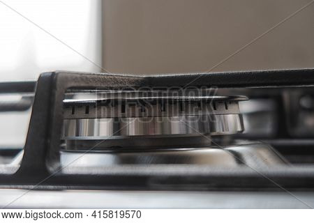 Silver Pan On A Modern Silver Gas Stove In The Kitchen Close-up.
