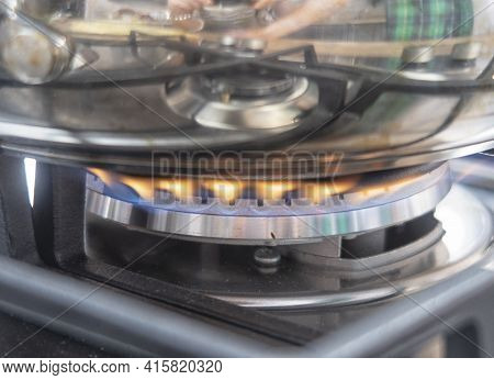 Silver Pan On A Modern Silver Gas Stove In The Kitchen Close-up.