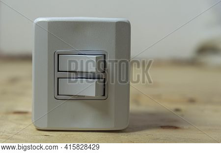 Double Switch Electrical Switch On Wooden Background