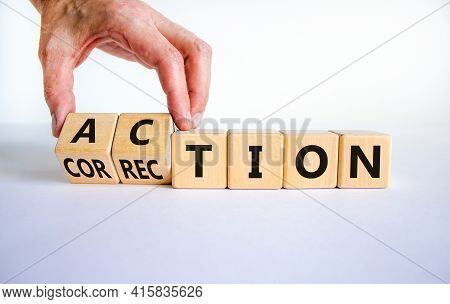 Action Or Correction Symbol. Businessman Turns Wooden Cubes And Changes The Word Correction To Actio