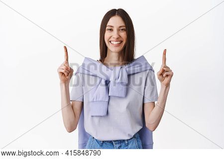 Read This Sign Above. Smiling Friendly Girl Pointing Fingers Up, Showing Best Promotional Deal, Shop