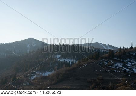 Snow-capped Mountain Peaks On A Winter Sunny Day. Carpathians. Ukraine. The Outskirts Of The Village