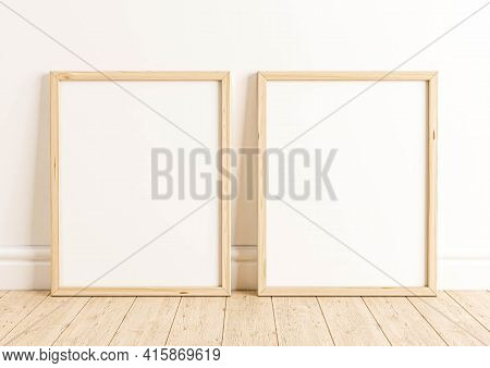 Double 8x10 Vertical Wooden Frame Mockup On Wooden Floor And White Wall. Two Empty Poster Frame Mock