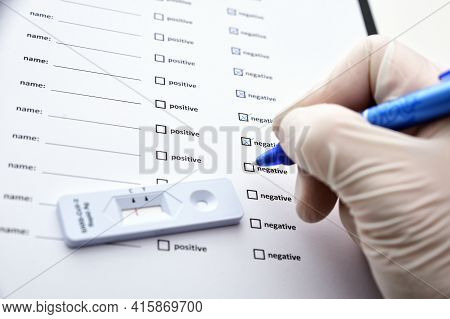 Hands Of Unrecognizable Doctor Or Nurse Filling Coronavirus Test Form. Covid-19 Test. Medical Test F