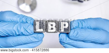 Lbp Low Back Pain - Word From Stone Blocks With Letters Holding By A Doctor's Hands In Medical Prote