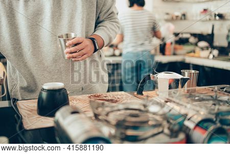 Barista Measure Coffee Powder And Brewing Black Moka Coffee Using Moka Coffee Maker.