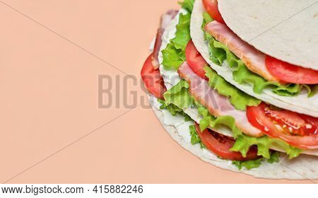 Italian Street Food. Piadina With Ham, Cheese And Tomatoes Close-up View. Stack Of Piada Made Of Tor