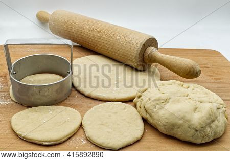 Italian Tigelle Dishes In Preparation, Round Form Metallic Tool, Rolling Pin On Wooden Table