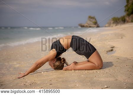 Yoga Practice On The Beach. Caucasian Woman Practicing Paripurna Ustrasana, Full Camel Pose. Kneelin