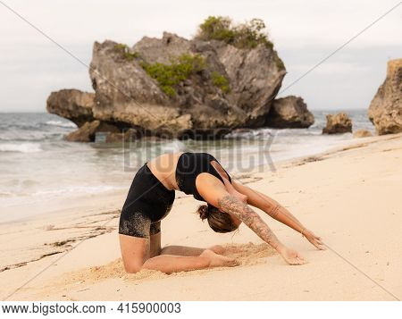 Yoga Practice On The Beach. Caucasian Woman Practicing Paripurna Ustrasana, Full Camel Pose. Kneelin