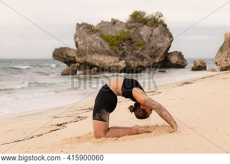 Yoga Practice On The Beach. Caucasian Woman Practicing Paripurna Ustrasana, Full Camel Pose. Kneelin