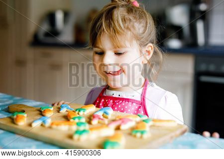 Cute Little Toddler Girl And Fresh Baked Homemade Easter Or Spring Cookies At Home Indoors. Adorable