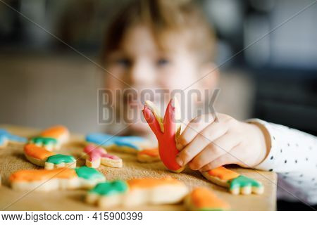 Cute Little Toddler Girl And Fresh Baked Homemade Easter Or Spring Cookies At Home Indoors. Adorable