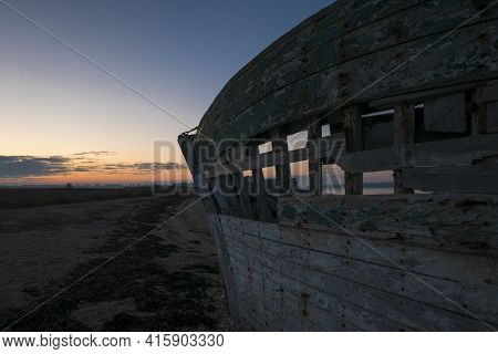 Beautiful Sunset And Wooden Shipwreck Standing On The Beach Taken From The Island Of Arz In Brittany