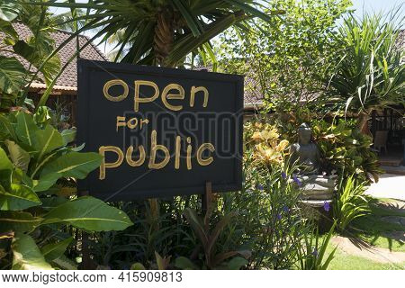 Ubud, Indonesia - March 9: Flourish Garden With Welcome Sign Board With Statue Of Buddha In The Back