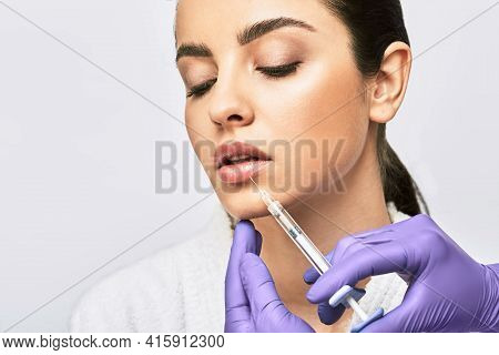 Lip Augmentation Procedure. Syringe With Lips Filler Near Beautiful Womans Mouth, Injections For Inc