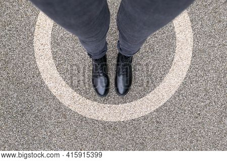 Black Shoes Standing In White Circle On The Asphalt Concrete Floor. Comfort Zone Or Frame Concept. F
