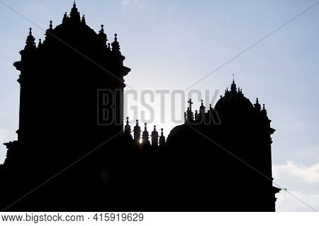 Silhouette Of Twin Towers And Dome Of The Historic Iglesia De La Compania In Cusco. Peru. The Church