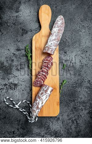 Fuet Salami Cut In Slices. Traditional Spanish Sausage On Wooden Board. Fuets Catalan Dry Sausages. 