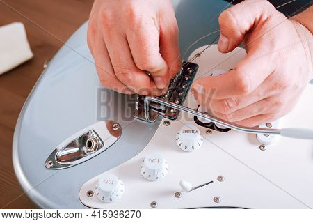 Guitar Master Making Professional Guitar Maintenance, Hands With Tools Close Up. Guitar Technician R