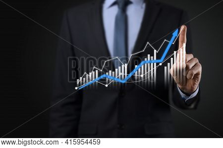Business Man Holding Holographic Graphs And Stock Market Statistics Gain Profits. Concept Of Growth