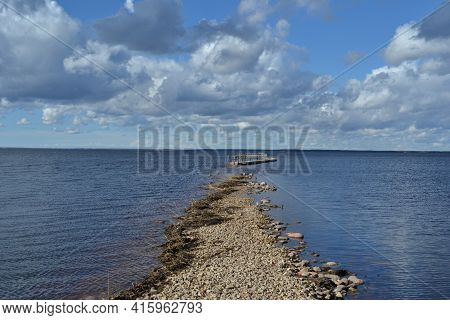 Landscape With A Lake, Which In The Spring Floods Flooded A Wooden Footpath Immersed In River Water.
