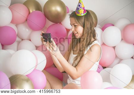 Lovely Lady In Pajama Making Selfie In Her Bedroom Using Phone. Happy Birthday. Girl Is  Lying On Be