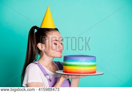 Side Profile Portrait Of Pretty Birthday Girl Keeping Smelling Colorful Festice Cake Isolated On Viv