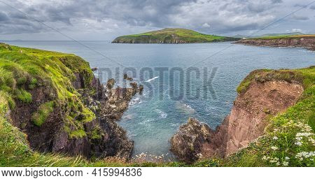 Large Panorama With Dingle Lighthouse And Bay Surrounded By Cliffs. Dingle Peninsula And Wild Atlant