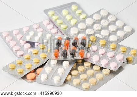 A Bunch Of Pill Packs On A Gray Background Close-up. The Concept Of Medicine And Drug Treatment