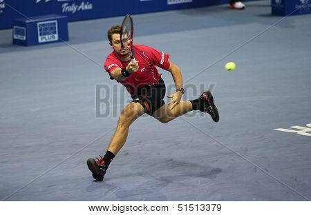 KUALA LUMPUR - SEPTEMBER 26: Stanilas Wawrinka hits a return a match against Marcos Baghdatis at the Malaysia Open 2013 tennis played at the Putra Stadium, Malaysia on September 26, 2013.