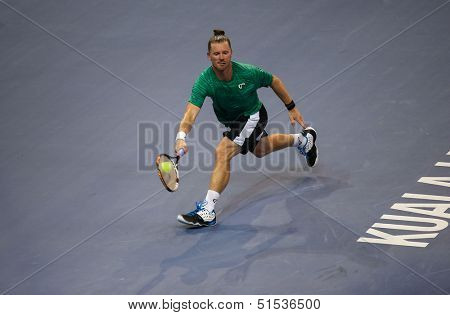 KUALA LUMPUR - SEPTEMBER 24: Alex Bogomolov Jr. (Russia) hits a return in a first round tennis match at the Malaysian Open 2013 played at the Putra Stadium, Malaysia on September 24, 2013.