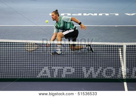 KUALA LUMPUR - SEPTEMBER 24: Alex Bogomolov Jr. (Russia) hits a return in a first round tennis match at the Malaysian Open 2013 played at the Putra Stadium, Malaysia on September 24, 2013.