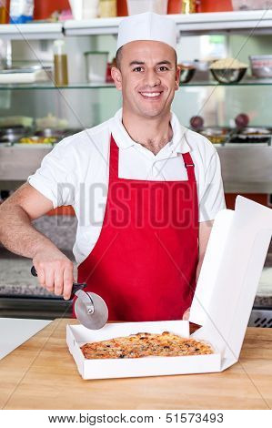 Chef Holding Pizza Cuter, Ready To Cut.