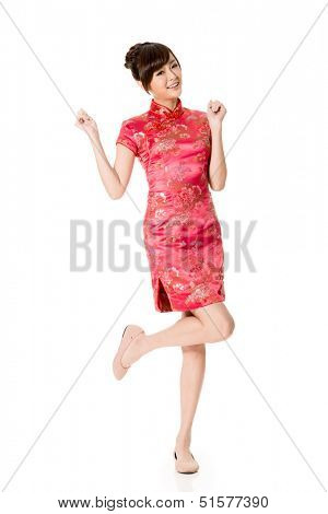 Smiling Chinese woman dress traditional cheongsam at New Year, studio shot isolated on white background.