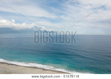 Beautiful seascape with shoreline and mountain in the distance. Shot at Qixingtan Beach in Hualien, Taiwan, Asia.