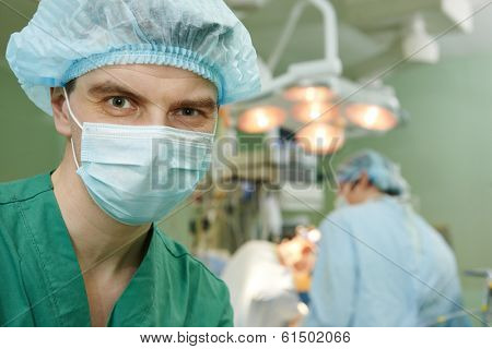 Male surgeon in uniform in front of cardiac surgery operation room at clinic