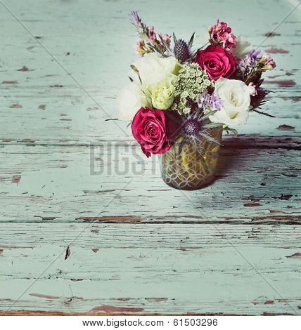 Fresh red roses and white flower bouquets in romantic style on grunge table, with space for text