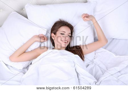 Young beautiful woman woke up in bed close-up