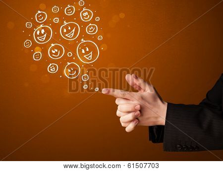 Group of happy hand drawed smiley faces coming out of gun shaped hands